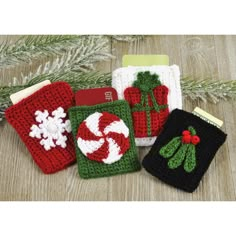 four crocheted christmas items are sitting on a table