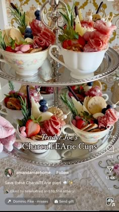 a three tiered tray with bowls filled with food