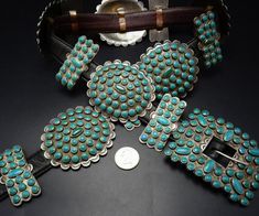 "VINTAGE TURQUOISE CLUSTER BELT DESCRIPTION: This spectacular belt features heavy gauge, hand-stamped sterling silver conchos and butterflies adorned with round snake eye specimens of natural turquoise. Circa 1950s, this museum quality belt will be a cherished addition to your collection of the very finest vintage Southwestern and Native American jewelry. MEASUREMENTS: Belt measures 40\" long x 7/8\" wide Belt is punched to fit from 33\" to 37\" Buckle measures 3 1/4\" x 2 5/8\" Conchos measure Vintage Concho Belt Buckles, Vintage Concho Belt Buckles For Formal Wear, Vintage Formal Concho Belt Buckles, Vintage Silver Concho Belt, Jewelry Measurements, Concho Belt, Wide Belt, Vintage Turquoise, Chic Accessories