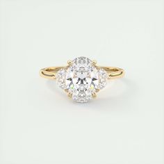 an oval diamond ring with three pear shaped diamonds in the center and two clawed shoulders