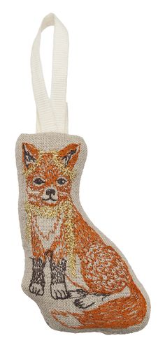 a small ornament with an orange fox on it