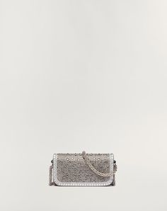 Valentino Garavani Locò small shoulder bag with rhinestone appliqué and Swarovski® covered VLogo Signature element. Equipped with both a detachable sliding chain strap and a detachable handle, this accessory can be worn as a crossbody/shoulder bag or carried as a handbag. - Palladium-finish hardware - Magnetic closure - Removable leather handle - Shoulder strap with removable sliding chain - Nappa leather lining. Interior: one slip pocket Shoulder strap drop length: min. 33 cm to max. 55 cm / min. 12.9 in. to max. 21.6 in. - Dimensions: W20xH11xD5 cm / W7.8xH4.3xD1.9 in. - Made in Italy Rhinestone Appliques, Small Shoulder Bag, Nappa Leather, Magnetic Closure, Leather Handle, Crossbody Shoulder Bag, Chain Strap, Valentino Garavani, Online Boutique