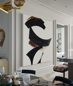 an elegant dining room with modern art on the wall