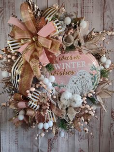 a wreath that is hanging on the side of a wooden wall with some decorations around it