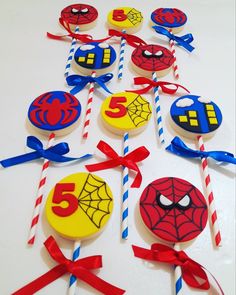 spiderman cupcakes and candy sticks on a table