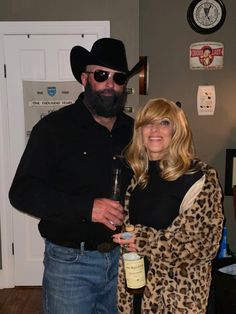 a man and woman standing next to each other holding wine bottles in their hands,