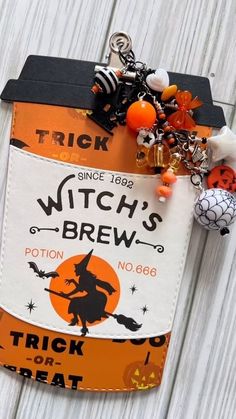 a trick or treat sign hanging on the side of a wooden fence with halloween decorations