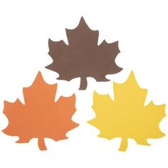 three different colored leaves on a white background