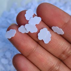 small white clouds are held in someone's hand