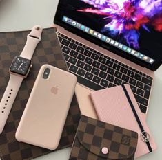 an open laptop computer sitting on top of a desk next to a wallet and cell phone