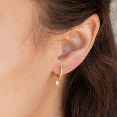 Elevate your everyday look with these elegant Diamond Huggie earrings. Dress up any outfit with these dainty pave hoops, perfect for wearing around the house or for a special occasion.• Material: High Quality Solid 925 Sterling Silver• Finish: Sterling Silver ∙ 18K Gold• Dimensions: Inner Diameter: 8mm Outer Diameter: 11mm• Featuring Dainty Pave Hoops with a dangling 3mm CZ Diamond stone SKU: RR-ER227 Elegant Earing Design, Everyday Earrings Simple Classy Gold, Minimalist Diamond Jewelry, Denty Jwellery, Gold Dainty Earrings, Simple Earrings Gold Indian, Dainty Earing, Cute Diamond Earrings, Earings Design Modern