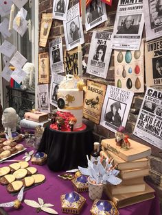 a table topped with lots of books and cakes