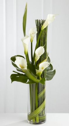 a tall vase with white flowers in it