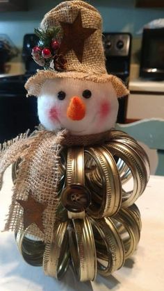 a snowman made out of metal coils on top of a table