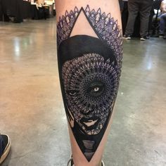 a person with a black and white tattoo on their leg