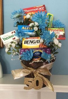 a vase filled with candy and flowers on top of a table next to a sign