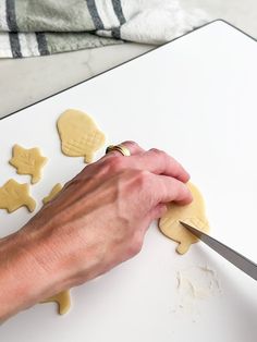 a person cutting out cookies with a knife