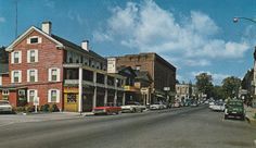 an old town street with cars parked on both sides