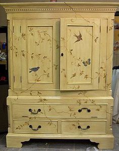 an armoire with birds painted on it