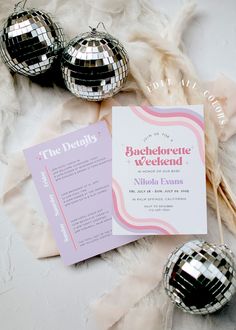 some disco ball decorations and a card on a white table cloth with the words bachelor weekend written in it