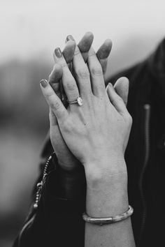 black and white photograph of two hands holding each other