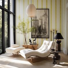 a white chaise lounge chair sitting in front of a window next to a lamp