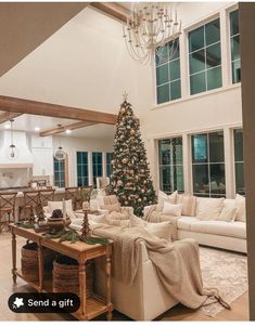 a living room filled with furniture and a christmas tree in the middle of the room