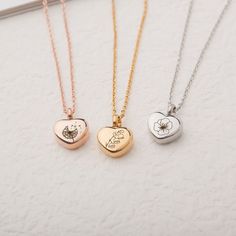 three necklaces with different designs on them