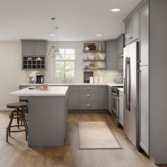 a kitchen with gray cabinets and stainless steel appliances