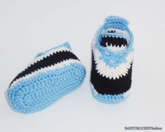 a pair of blue and white crocheted slippers