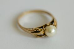 Very elegant vintage 9ct gold ring with a beautiful design and large central pearl. The ring is hallmarked for Birmingham, 9ct gold, the date letter S stands for 1967-1968. The size of the ring is UK P or EU 56. The ring is in excellent condition, with no deformations, only a couple of very minor imperfections and marks on the surface commensurate with its age. The pearl is undamaged, and well set. It is a wonderful piece of jewellery suitable as a gift or as an addition to a collection.  Please see all the photos for a more accurate description. *the jewellery box is for display and is not sold with the ring. Weight: 2,55 g Antique Hallmarked Pearl Ring For Formal Occasions, Victorian 14k Gold Pearl Ring For Formal Occasions, Antique 14k Gold Pearl Wedding Ring, Antique Gold Pearl Ring In 14k Gold, Vintage White Signet Ring For Formal Occasions, Vintage White Pearl Ring, Classic 14k Gold Pearl Ring, Vintage Gold Hallmarked Pearl Ring, Vintage 14k Gold Pearl Wedding Ring