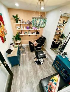 a hair salon with chairs and mirrors in the corner, lights hanging from the ceiling