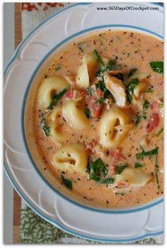 a white plate topped with pasta and spinach