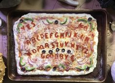 a pizza that is sitting on top of a pan with the letters written in it