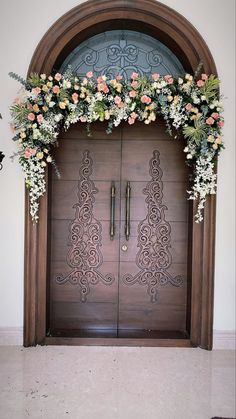 a large wooden door with flowers on it