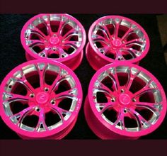 four pink rims and wheels are stacked on top of each other