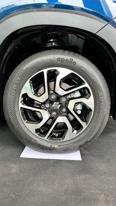 the front wheel of a blue pickup truck