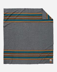 a gray blanket with multicolored stripes on it