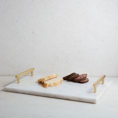 two pieces of bread on a white cutting board