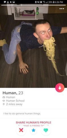 a man laying on the floor eating spaghetti