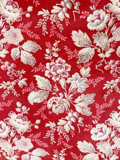 a red and white floral pattern on fabric