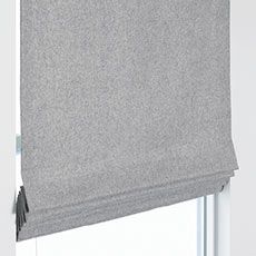 a window with a gray roller shade hanging from it's side