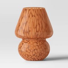 a brown vase sitting on top of a white table