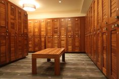 a room filled with lots of wooden lockers