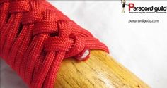 a red rope wrapped around a wooden pole