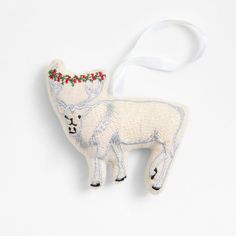 an ornament shaped like a sheep with a christmas decoration on it's head