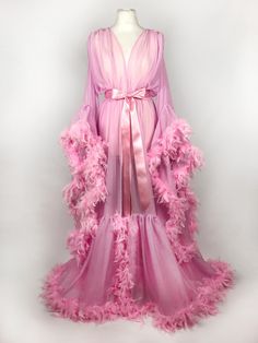 Beautiful chiffon dressing gown in Baby Pink.  Trimmed along the hem and the sleeve edges with fluffy chandelle feathers.  Ties around the waist with a matching chiffon belt - not satin as pictured! One size fits all due to the design and fullness of the robe.  Perfect for family gatherings, walking the dogs as well as taking out the rubbish.  Please expect some feathers to shed - no one can look this fabulous without losing a few feathers. Walking The Dogs, Fancy Robes, Diy Luxury, Pink Bow Dress, Feather Gown, Runway Gowns, Night Fashion, Baby Rosa, Night Gowns