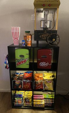 a shelf filled with food and snacks on top of a hard wood floor