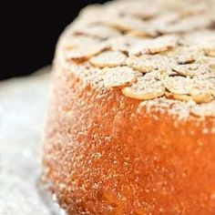 a round cake with powdered sugar on top