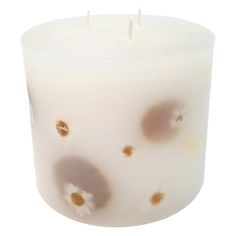 a white candle with brown spots on it